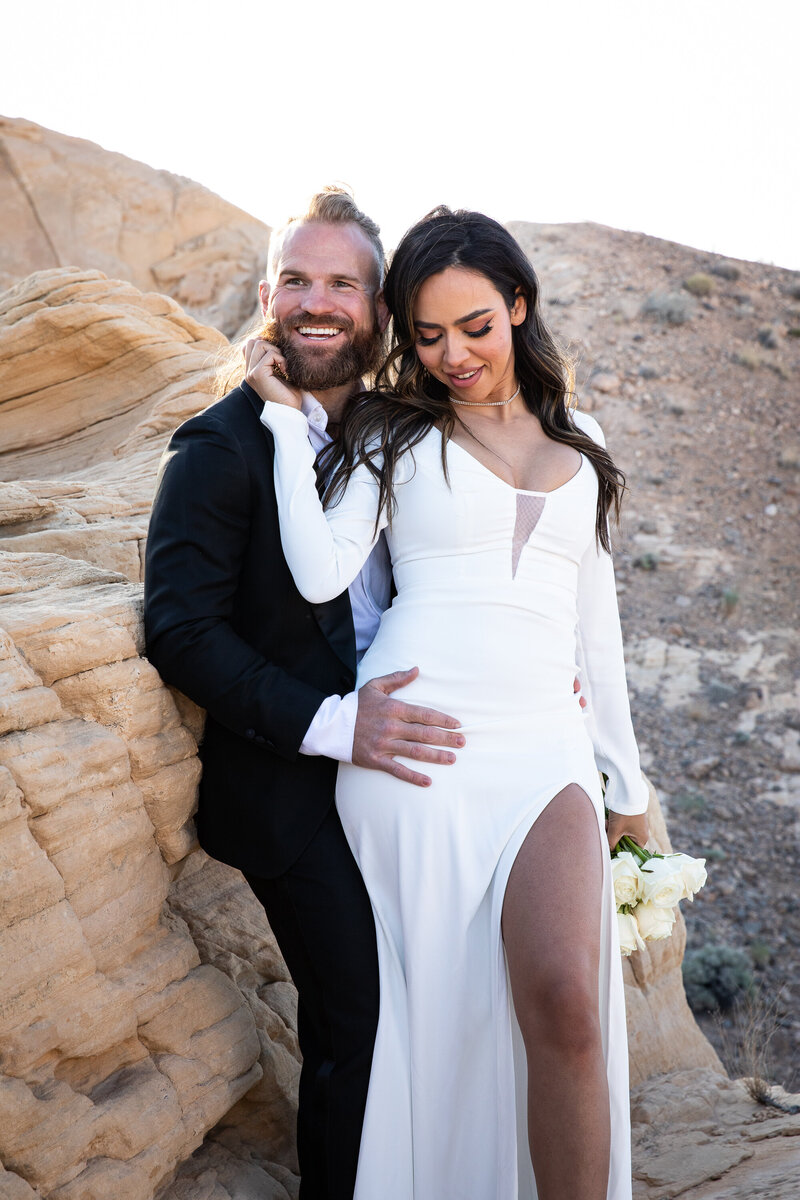 A bride and groom, captured by an Austin wedding photographer, striking a pose in the beautiful desert landscape.
