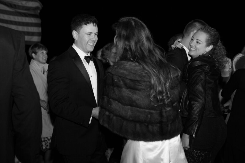 Black & White Photo of Bride and Groom with a few guests in background | Wedding Photography