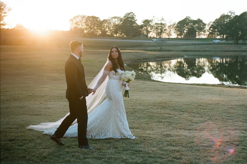 Bride and Groom kissing in between columns