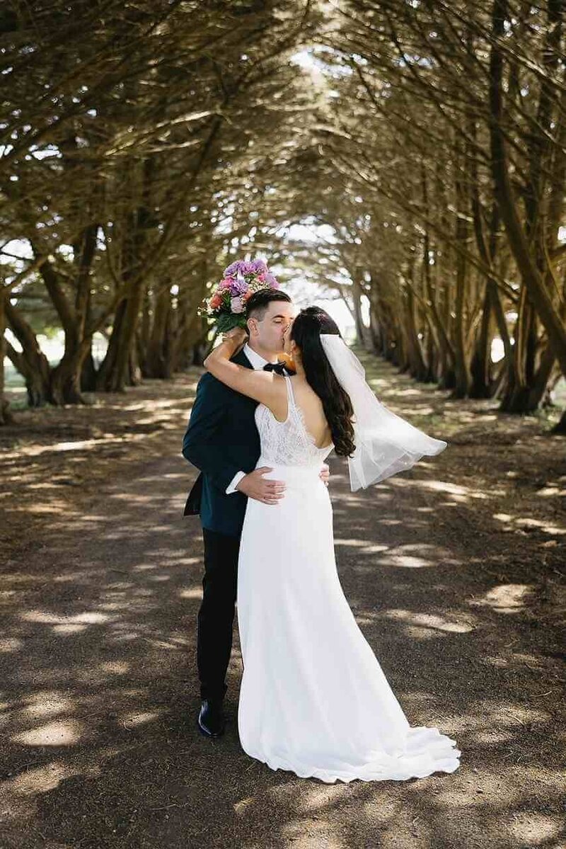Bride and groom hugging each other.