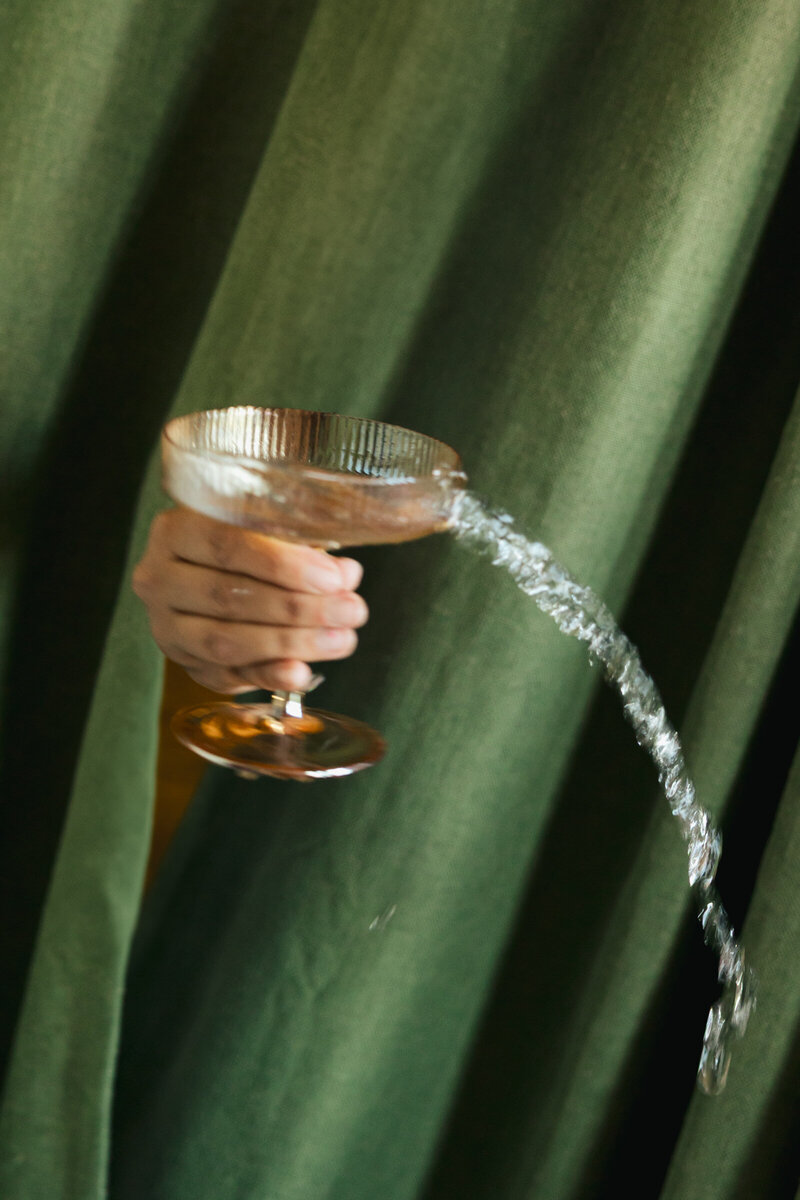 spilling champagne drink