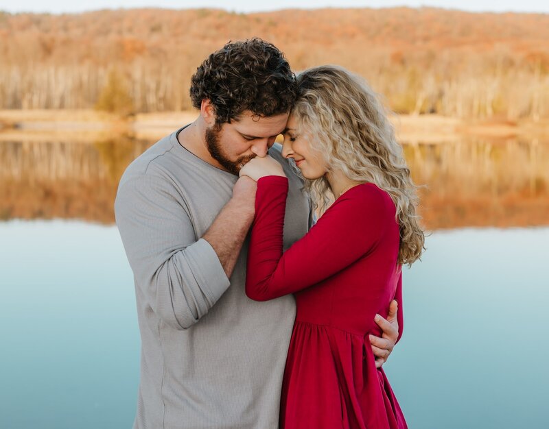 Couple kissing at sunset for engagement photos