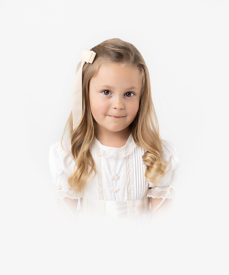 5 year old girl photographed in an heirloom dress in a heirloom bust portrait