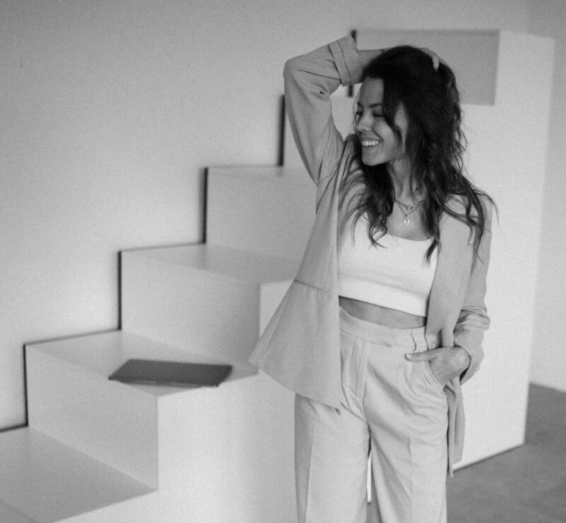 Brand and Web Designer Kim standing in front of a staircase