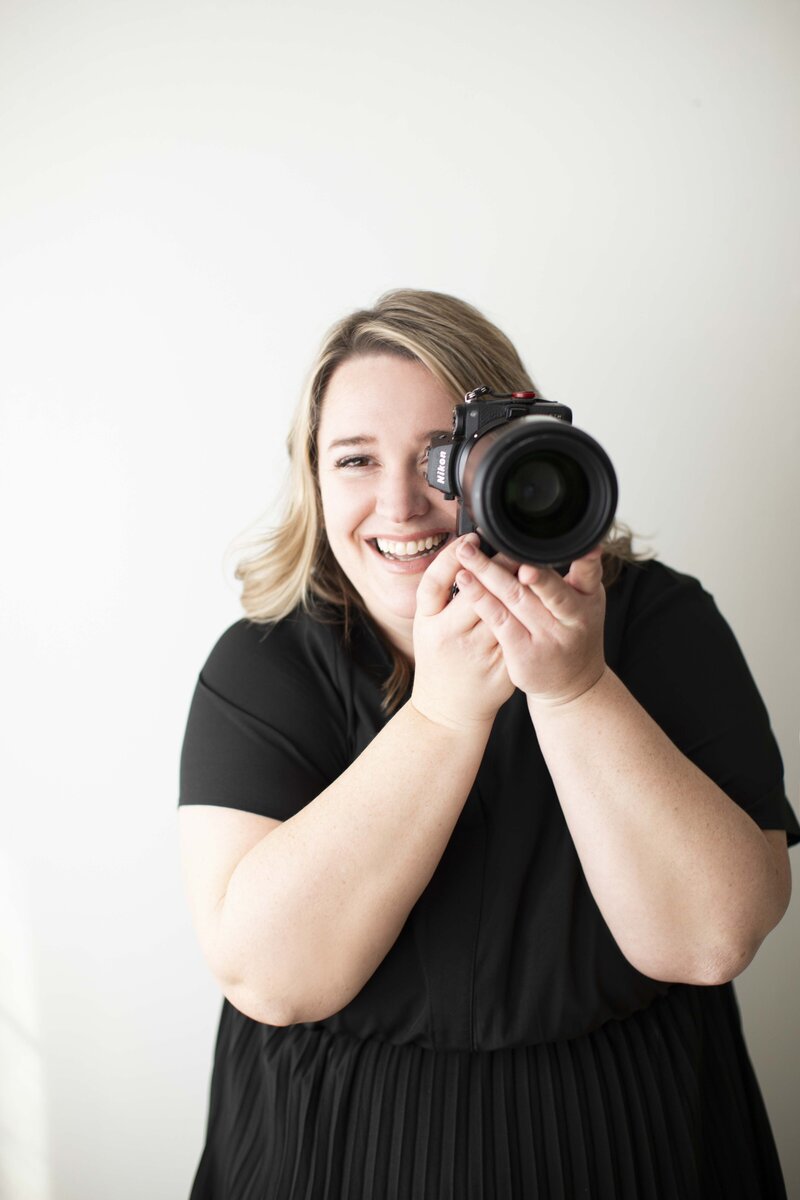 Kate posing with a camera