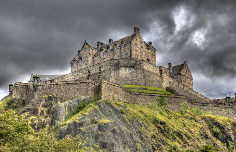 Edinburgh Castle standing tall atop Castle Rock beneath moody Scottish skies — a powerful symbol of history, strength, and the romantic backdrop that sets the tone for Kat Mackenzie’s Work in Progress Literary Tour.