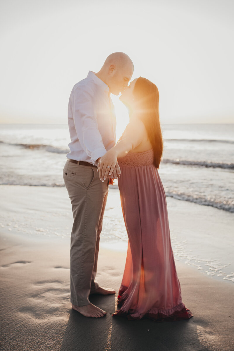 engagement session with the sun setting on hunting island state park