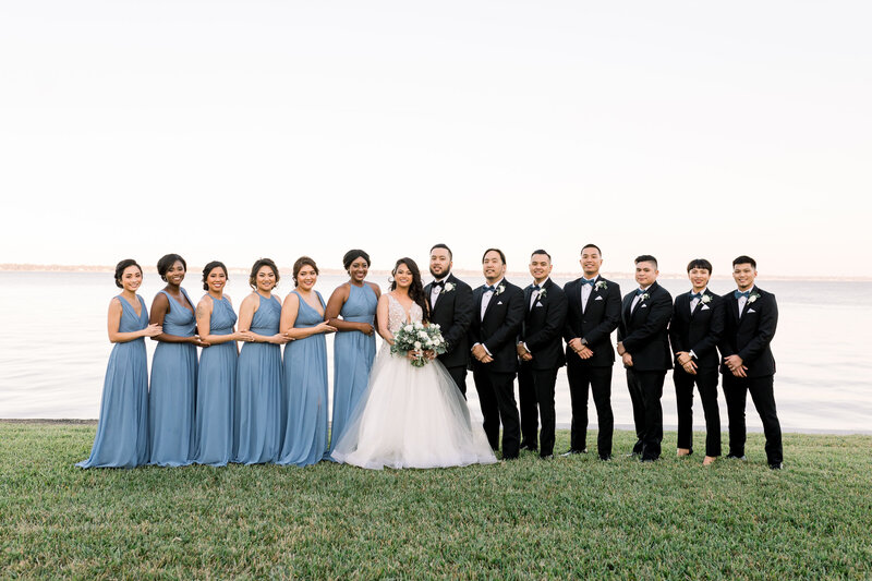 Bridal party poses on the waterfront at the Florida Yacht club