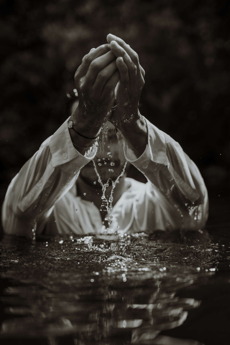 black and white photo of man coming out of water