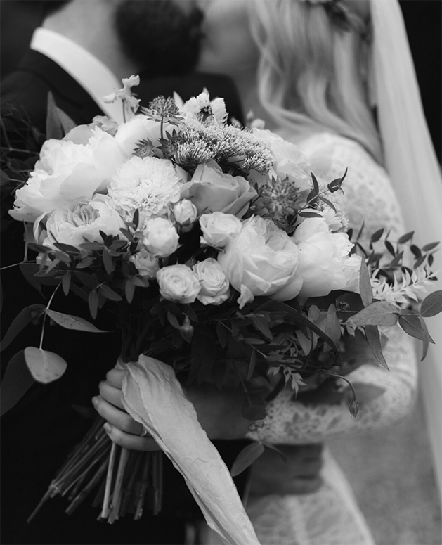 Bride and Groom kissing with bouquet