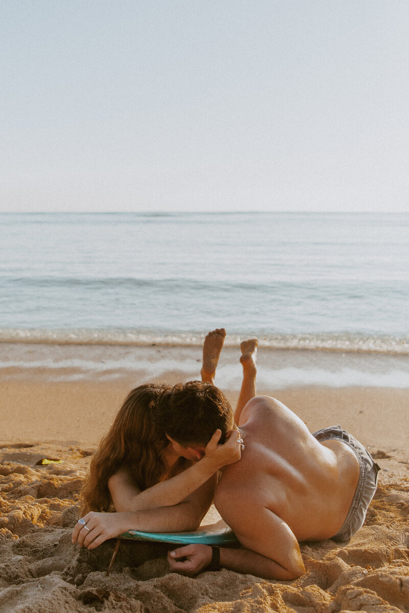 Couple kissing on surf board