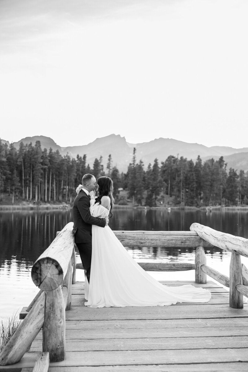 Bride and groom sharing an intimate kiss during their Colorado elopement, with dramatic mountain views in the background.