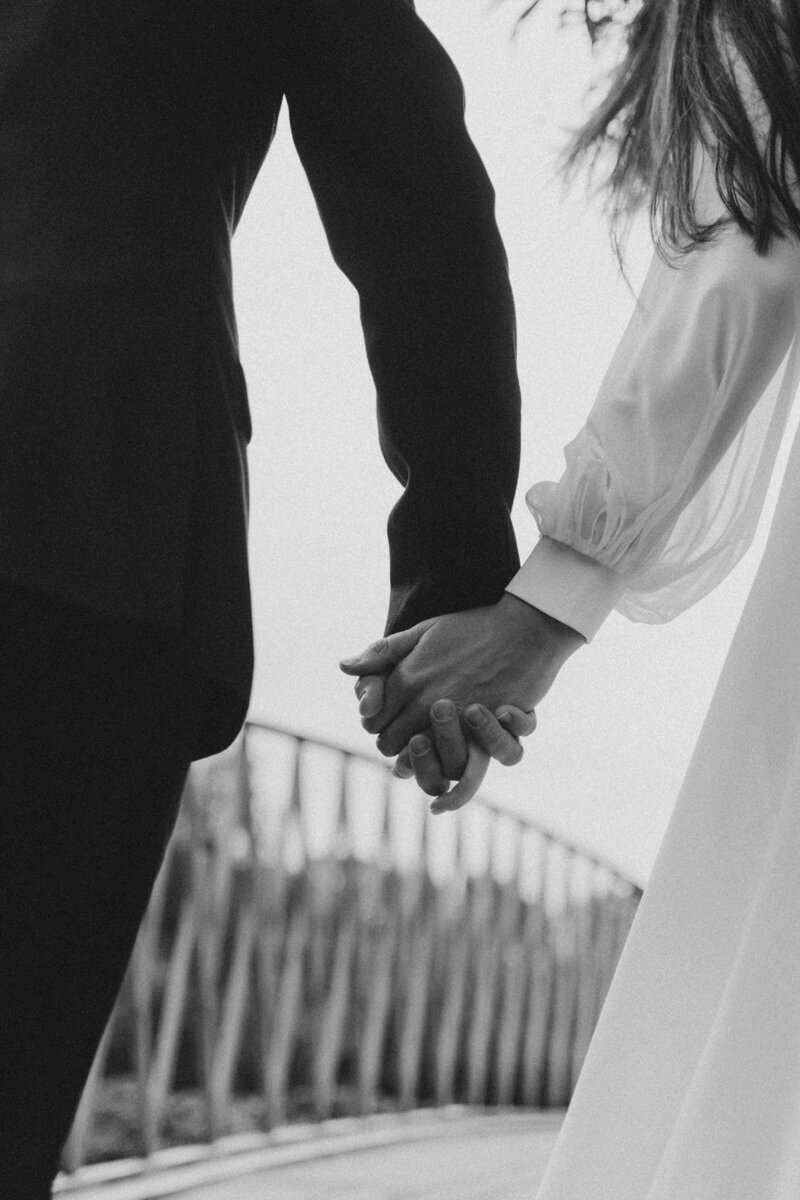 A faceless couple holds hands, representing the appeal of The Crush Collective wedding expo for couples getting married.
