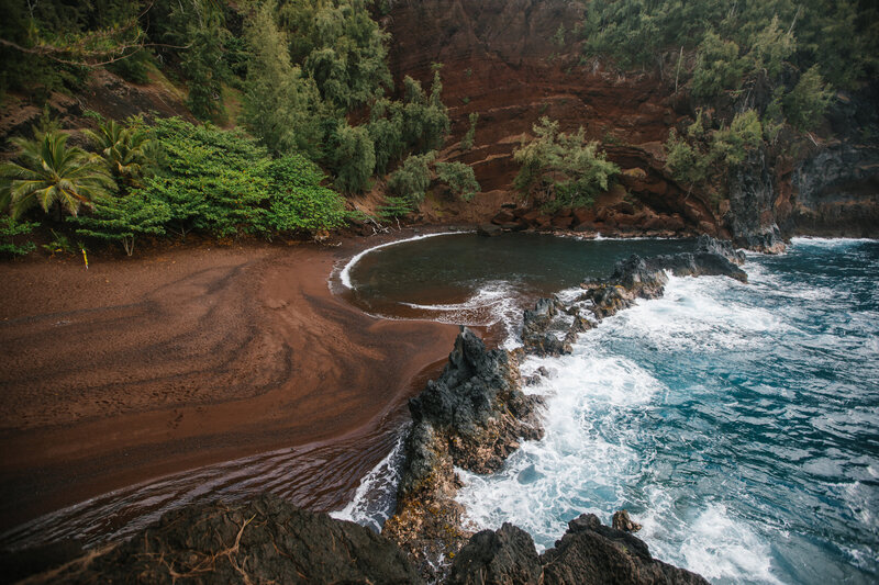 A beach with red sand in hawaii