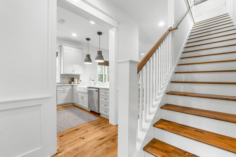Chic hallway and staircase with natural light at Tangerine Dream, a 30A beach house rental near Grayton Beach.
