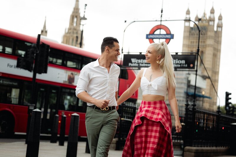 A happy couple wearing nice outfits luthing and enjoying their time in front of Westminster underground station and BigBen