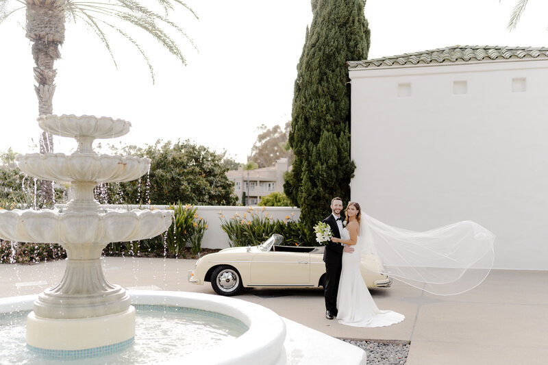 Marbella Golf Course fountain and vintage car with bride and groom