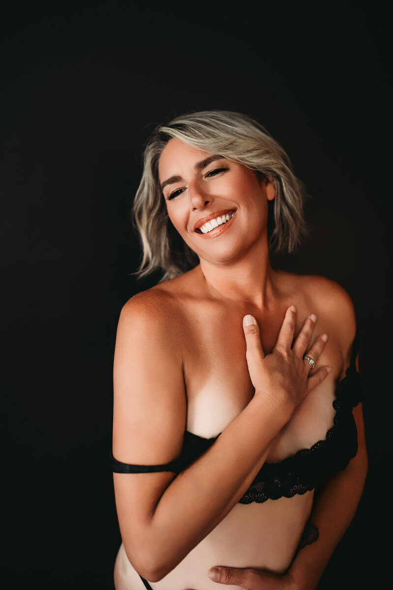 Girl in boudoir pose hand on face