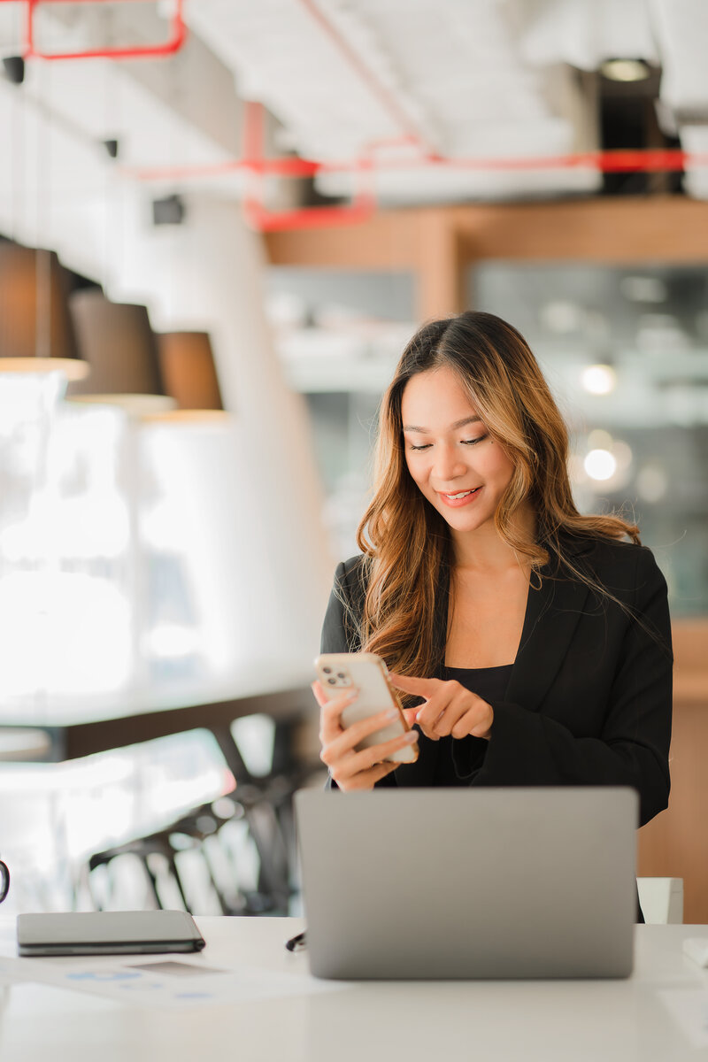 A woman uses her phone to call a website design agency in florida