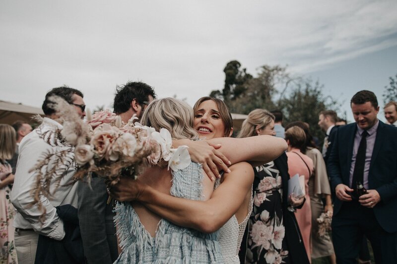 emotional moment with bride hugging a guest at melbourne ceremony