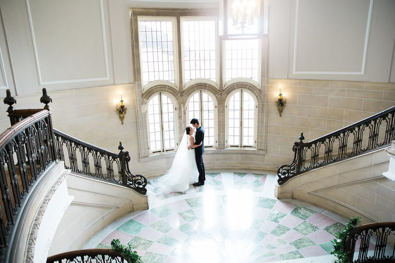 bride and groom in grand staircase