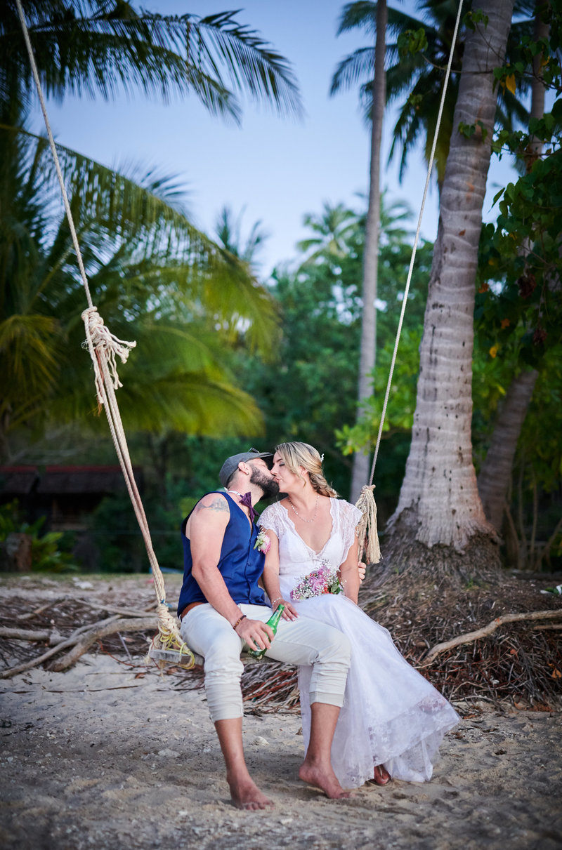 Couple sitting on swing kissing