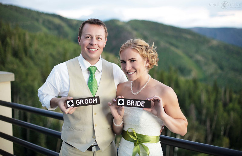 couple holds cute Black diamond signs at their Steamboat Springs Resort Wedding in Colorado