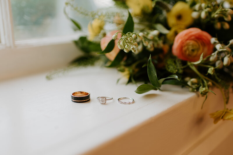 close up ring photo with the bridal bouquet behind it at a Richmond wedding venue