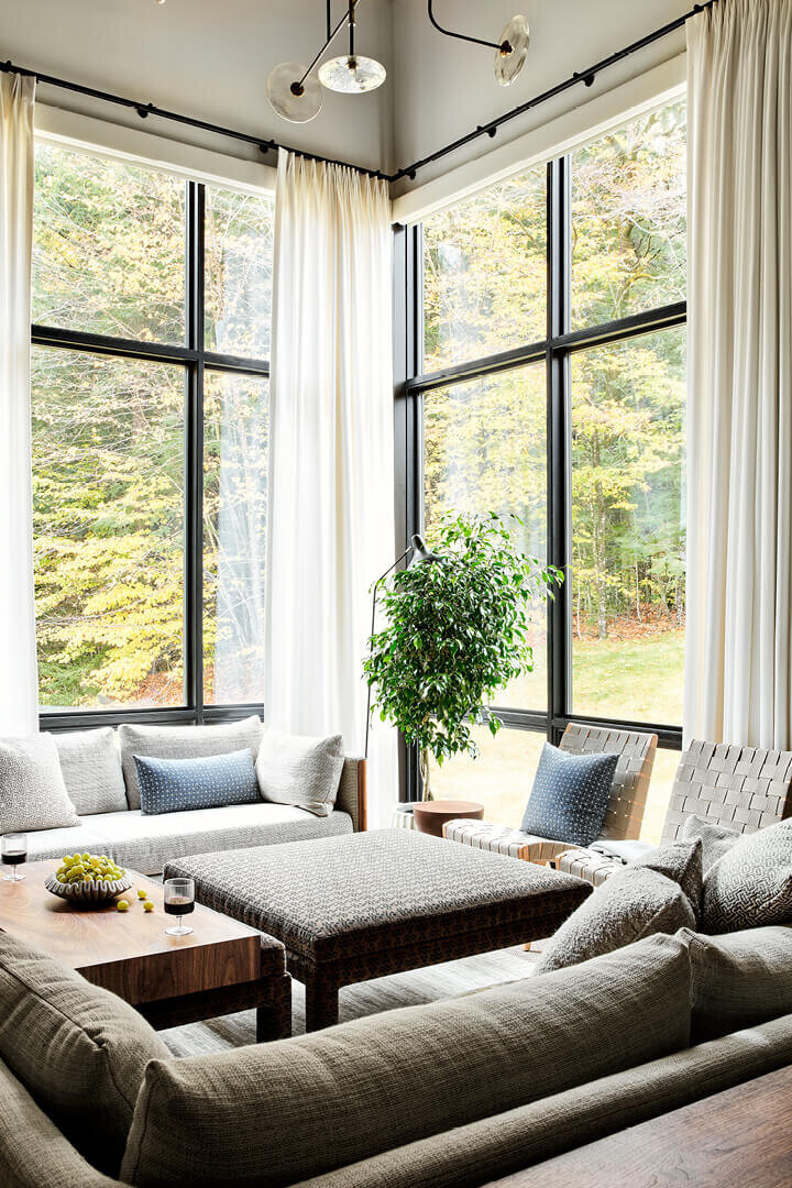 Interior design firms Boston created a modern Vermont mountain house blending natural materials, warm tones, and panoramic mountain views.
