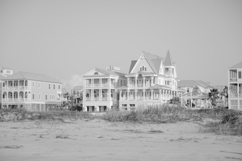 Coastal scene of high-end beachfront homes in Galveston, Texas, captured in a black and white editorial style by a luxury wedding photographer.

