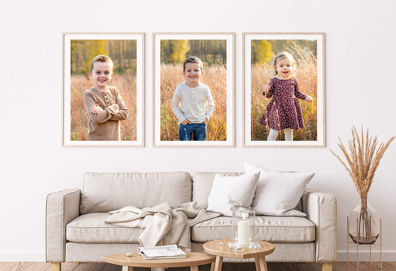 Neutral modern living room interior featuring large print family portraits.