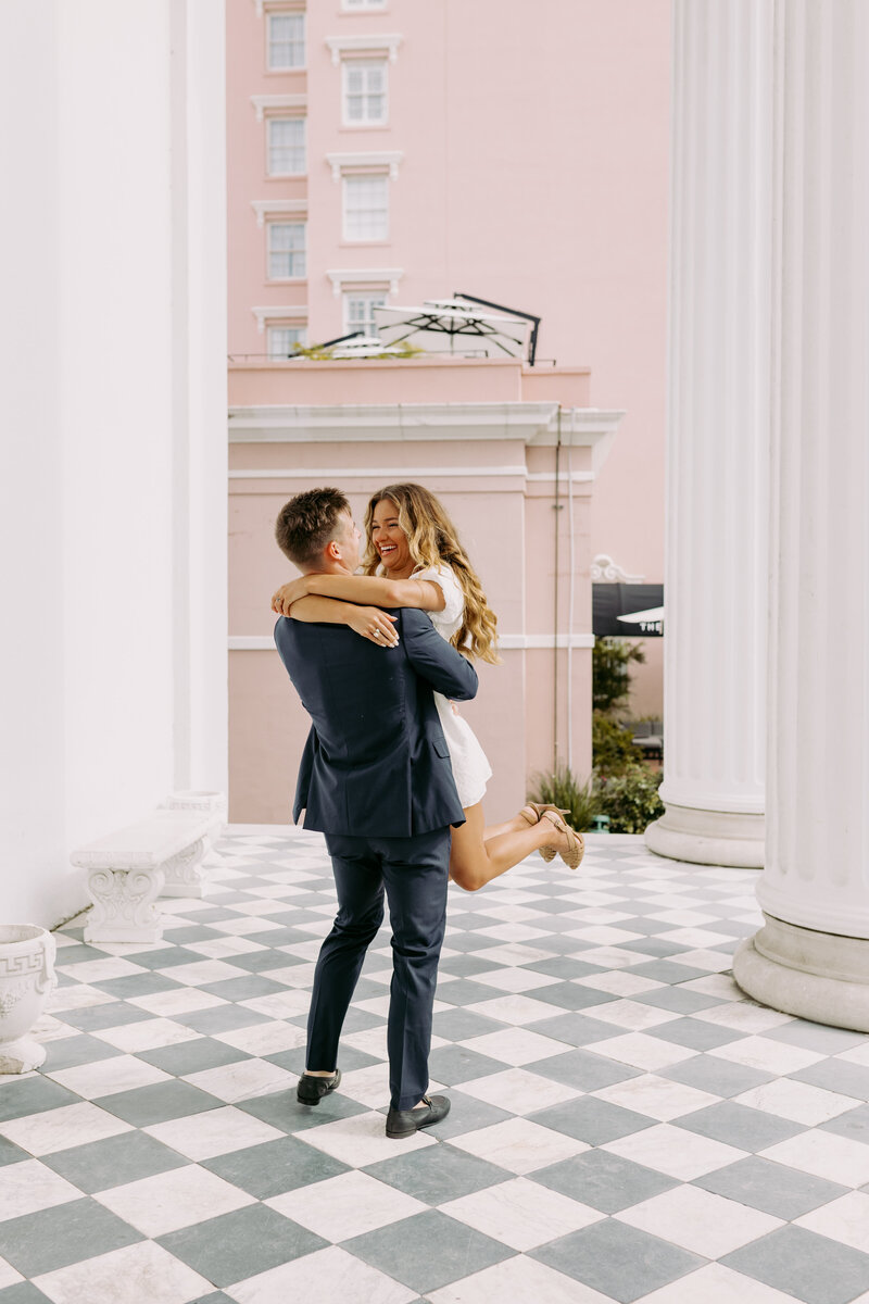 Bride and groom holding their hand while walking together at sunset on the evening of their wedding 