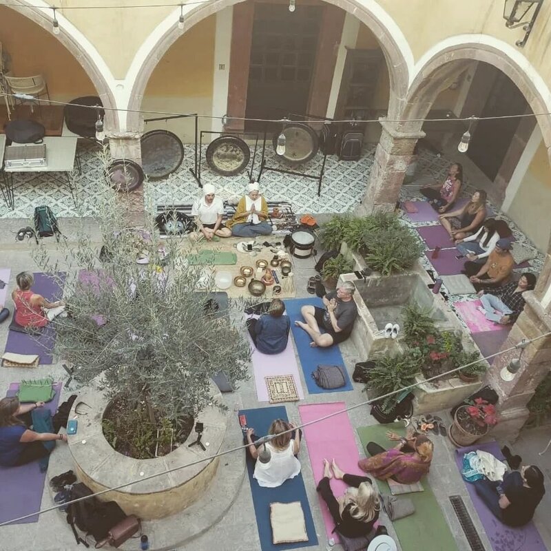 Roberto and Ana of Puerta Al Corazón in San Miguel De Allende offer powerful sound healing, gong therapy, meditation sessions, and yoga classes at their wellness center, creating transformative group and private experiences through EnForma.