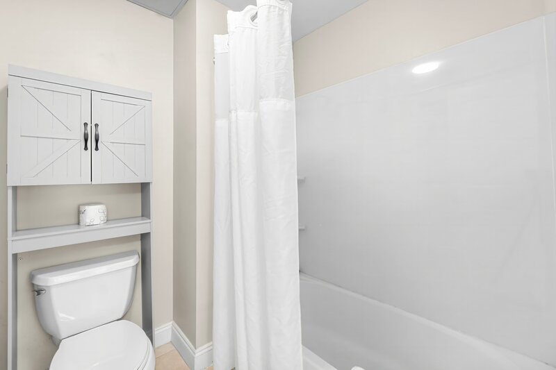 over the toilet shelving unit with double doors