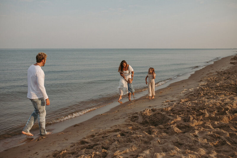 Family playing together on the beach during their Michigan session