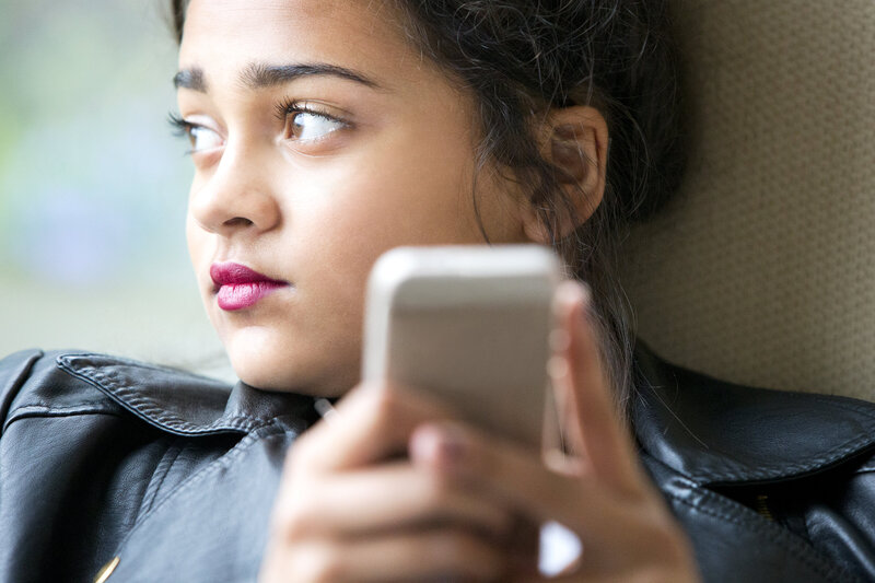 Young teen looking away from phone. Did you know that we have therapists for teen anxiety?  Call us today