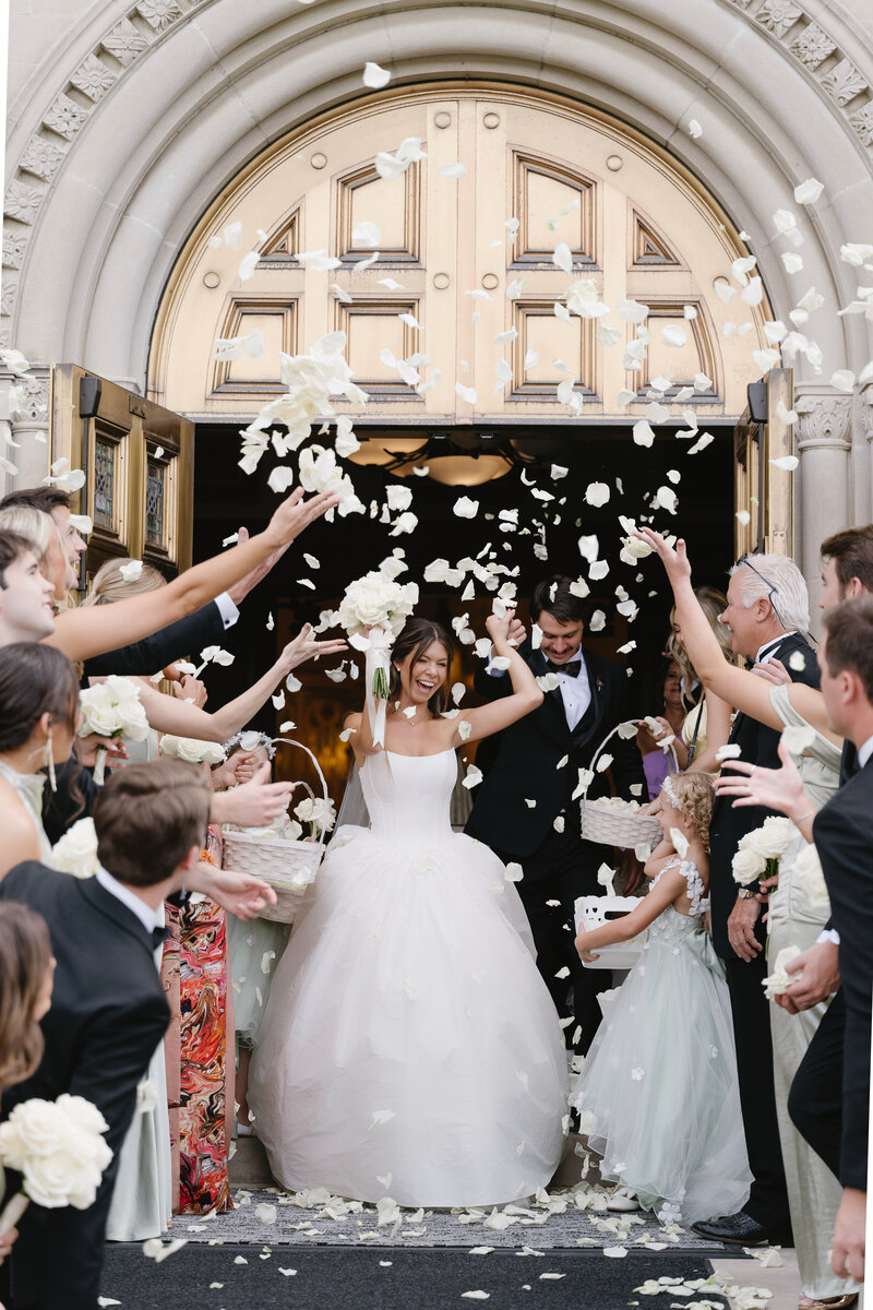 Bride and groom walking down the aisle holding hands in Sicily