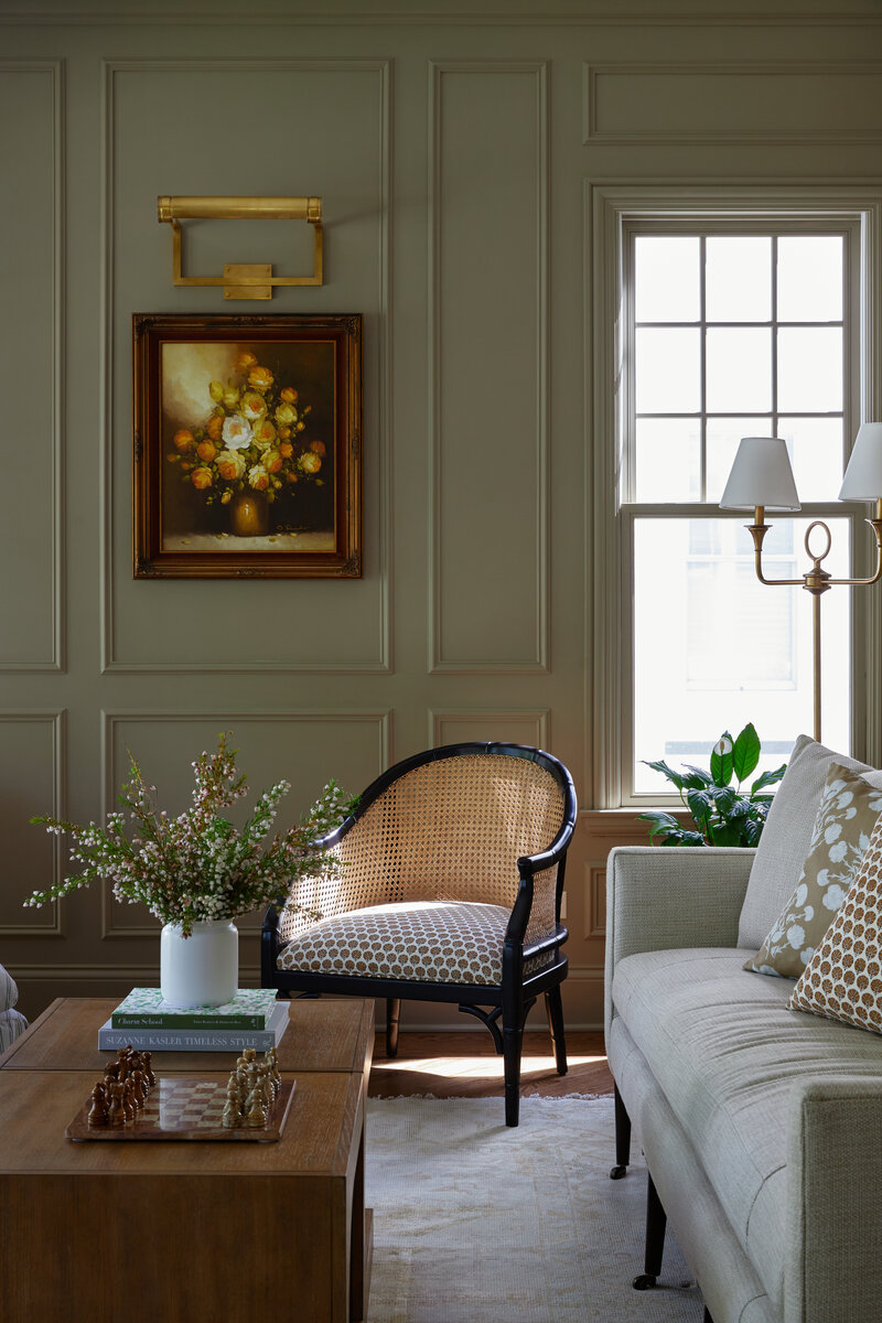 Green living room with wainscoting and neutral accents 