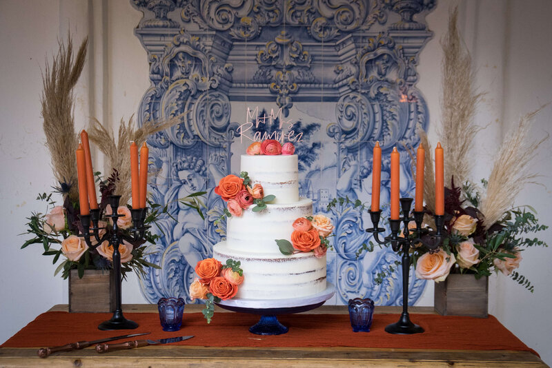 Weddings in Newport Beach cake on table with candlesticks and flowers