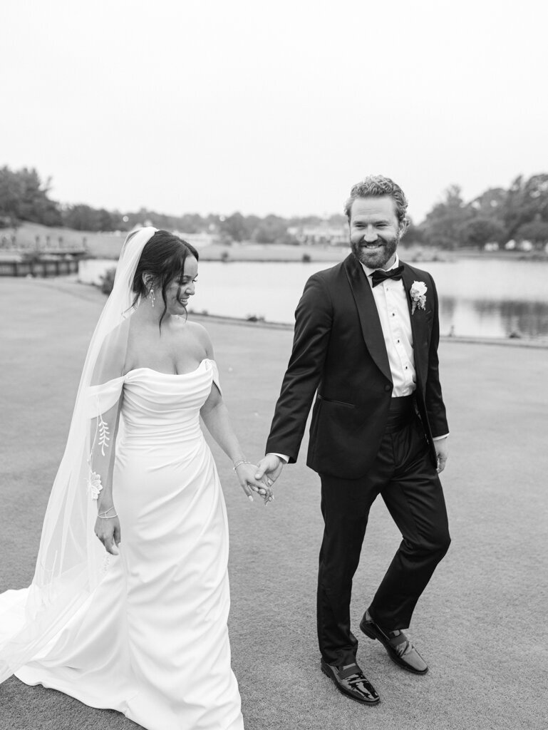 bride and groom walking on the golf course, taken by Baltimore wedding photographer nicole simensky