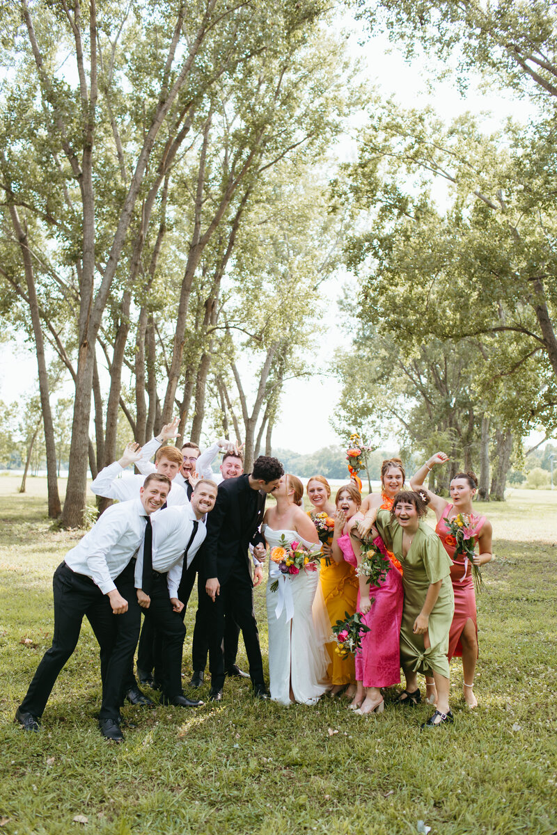 wedding party celebrates with bride and groom with ashley cole photography