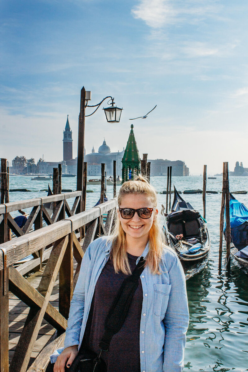woman standing by the gondolas in venice