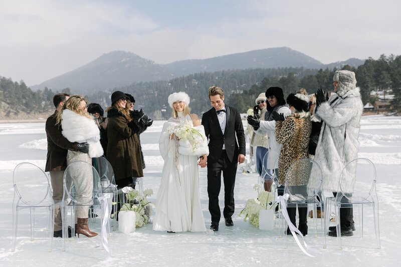 Bride and groom exiting their colorado mountain wedding ceremony at Evergreen Lake House