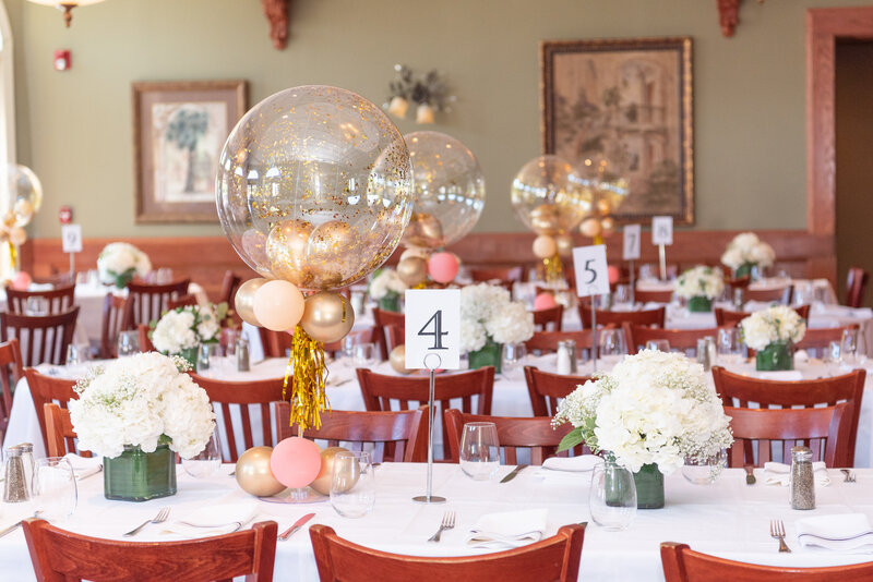 Balloon and floral table decorations at a birthday celebration.