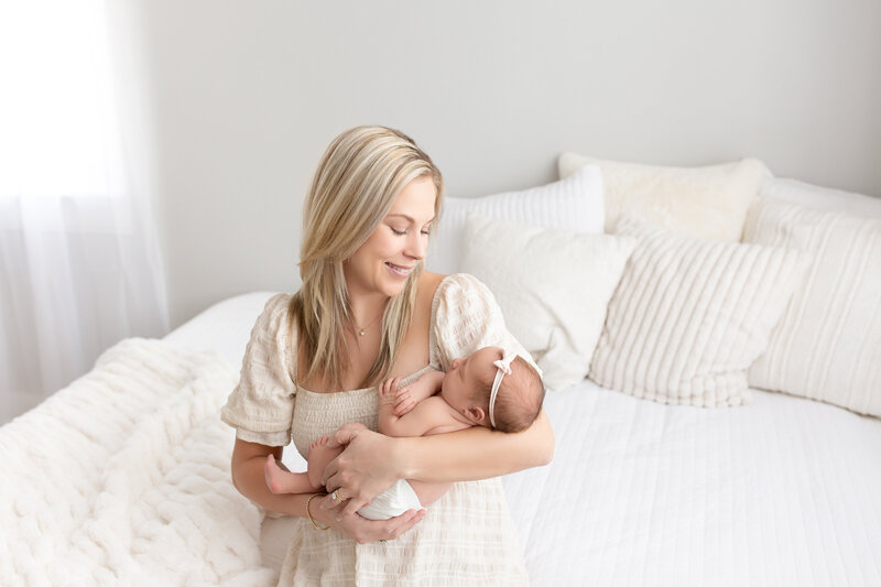 Mom holding newborn in studio