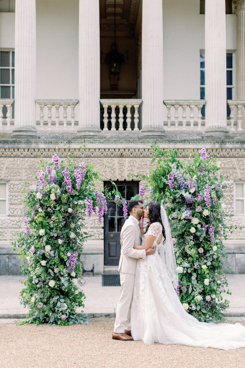 Bride and groom kiss after the ceremony at chiswick house and gardens are documented by Luxury UK wedding photography and videography team Philippa and Leo