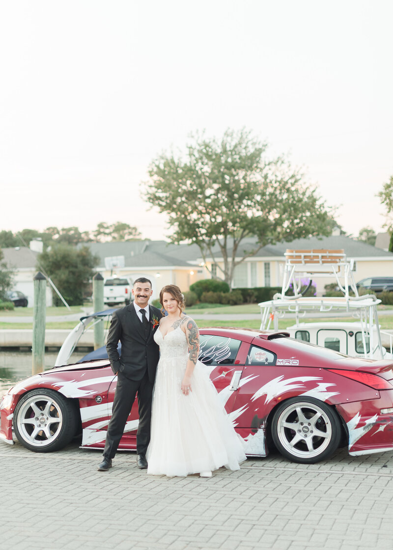 bride-and-groom-in-front-of-wedding-car-83