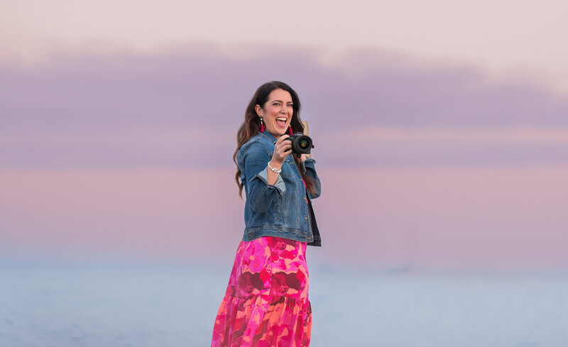 Photographer Missy <ayo is taking a photograph with her Sony a7iii camera at sunset with beautiful blue and purple colors.