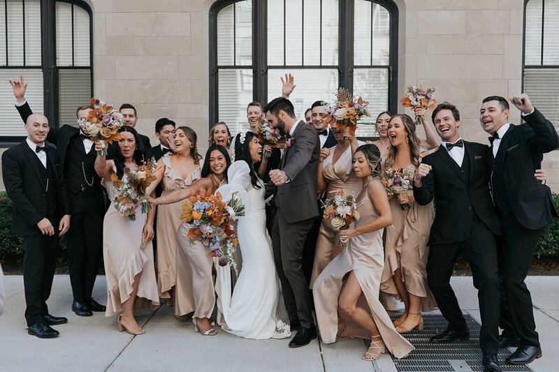 Wedding planning company bride and groom clients celebrating