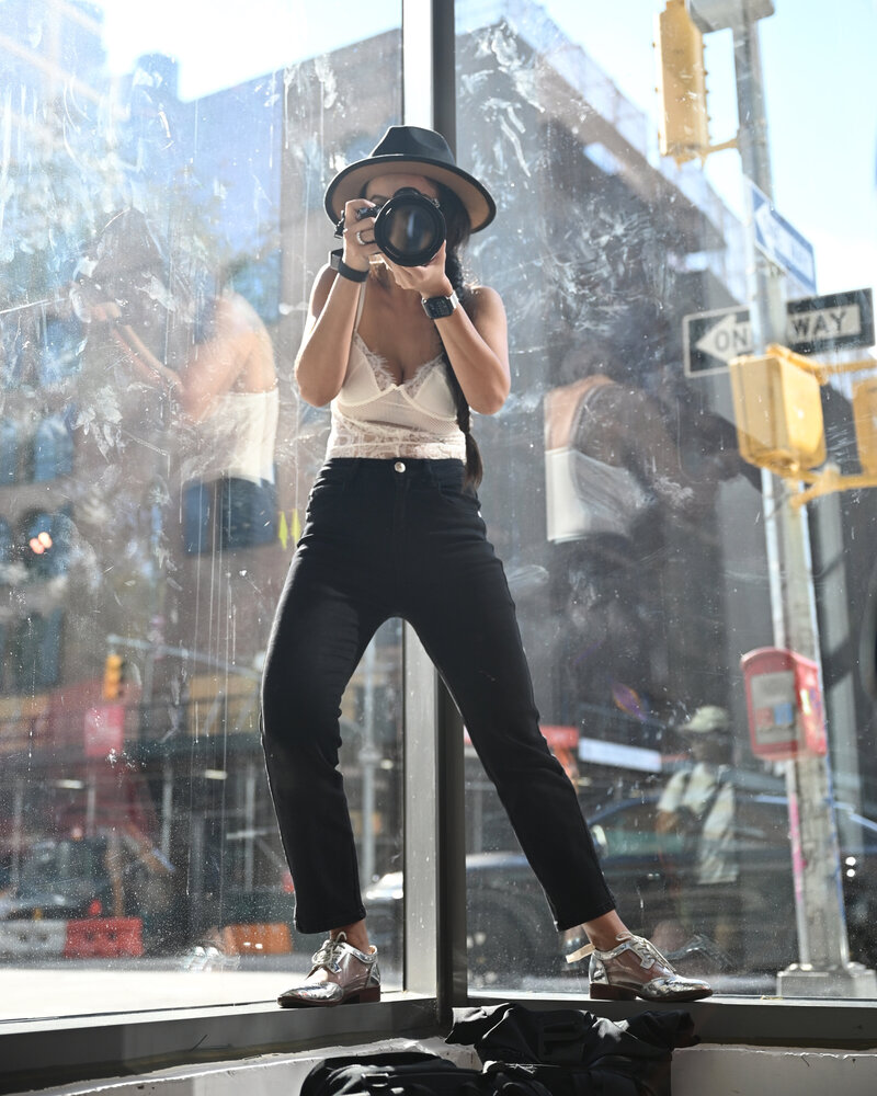 Photographer Holding a Camera and Reviewing Shots
